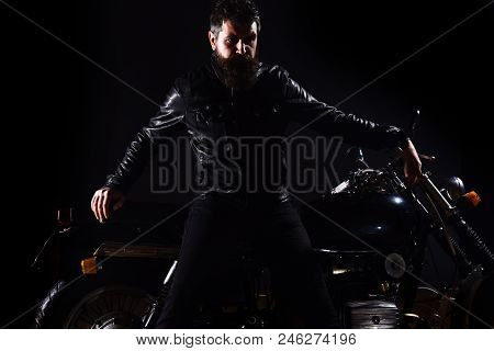 Macho, Brutal Biker In Leather Jacket Stand Near Motorcycle At Night Time, Copy Space. Man With Bear