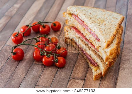 Wholemeal bread sandwich topped with Lyon rosette and butter