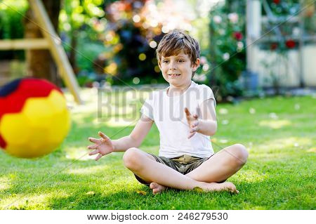 Happy Active Kid Boy Playing Soccer With Ball In German Flag Colors. Healthy Child Having Fun With F