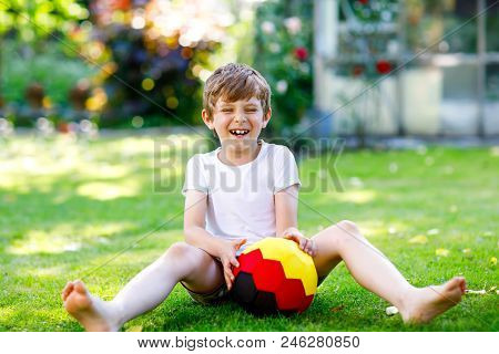 Happy Active Kid Boy Playing Soccer With Ball In German Flag Colors. Healthy Child Having Fun With F