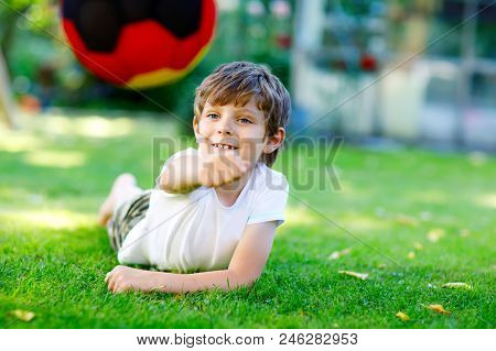 Happy Active Kid Boy Playing Soccer With Ball In German Flag Colors. Healthy Child Having Fun With F