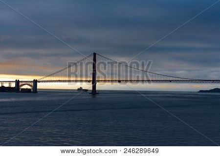 San Franciso, Ca -- January 25, 2016.  A Cargo Ship Sails Under The Golden Gate Bridge At Dusk In Wi