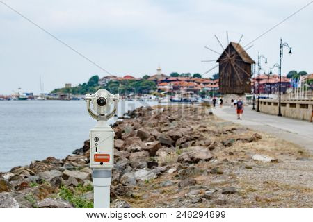 Old Coin Operated Touristic View Telescope With Blurred City Of Old Nesebar And Sea Landscape Backgr