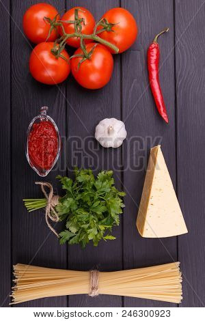 Tasty And Appetizing Tomatoes Parsley Chese Ketchup Garlic Hot Chili Peppers And Dry Pasta Are Lying