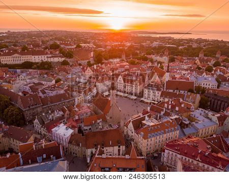 Beautiful Orange Sunset Over Old Town Of Tallinn In Estonia With The Raekoja Plats, Castle And Old M