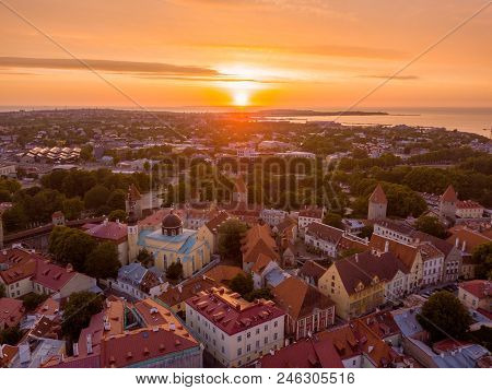 Beautiful Orange Sunset Over Old Town Of Tallinn In Estonia With The Raekoja Plats, Castle And Old M