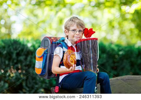 Happy Little Kid Boy With Glasses And Backpack Or Satchel On His First Day To School . Child Outdoor