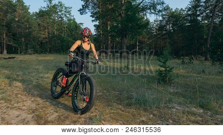 Fat Bike Also Called Fatbike Or Fat-tire Bike In Summer Riding In The Forest. Beautiful Girl And Her