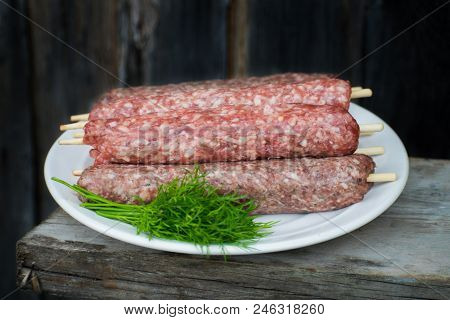 Raw Lulya Kebab From Meat On A White Plate.