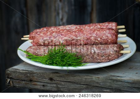 Raw Lulya Kebab From Meat On A White Plate.