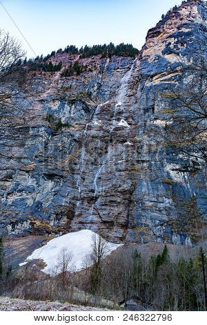 View Of The Staubbach Waterfall At Lauterbrunnen Village In Switzerland In The Winter