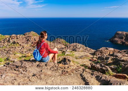 Tourist Woman With Backpack On Cap De Creus, Natural Park. Eastern Point Of Spain, Girona Province, 