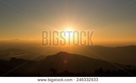 Orange Light Of The Sunset Over Mountains, Phu Chi Fa, Chiang Rai, Thailand.