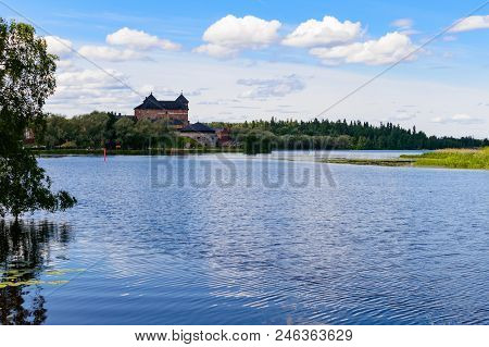 The Old Castle Of Hämeenlinna Is Behind The Lake
