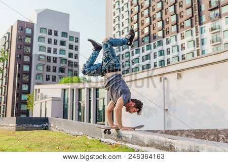 Skateboarder Handstand On Ramp On The Sunset.