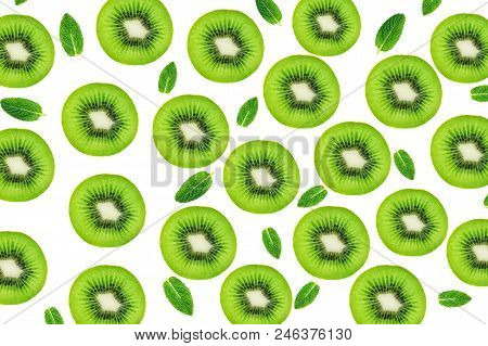 Creative Layout Made Of Kiwi Fruits Snd Mint Leaves. Many Slices Of Ripe And Juicy Kiwifruit. Flat L