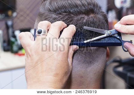 Men's Hair Styling And Grooming With The Help Of Scissors Machine And Hair Clippers In The Hair Salo