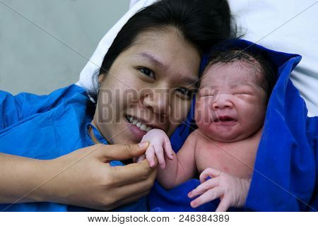 Mother Touch The Little Hand Of Her Childbirth , Baby Asian Girl On Hospital Beds At Maternity Ward