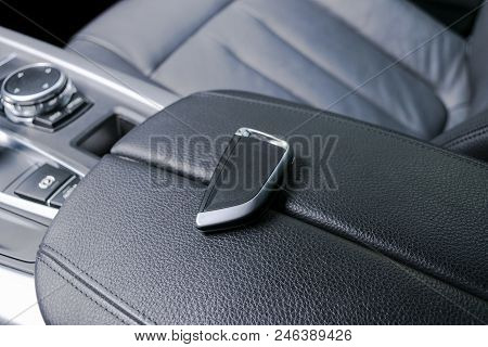 Closeup Inside Vehicle Of Wireless Key Ignition. Start Engine Key. Car Key Remote In Black Perforate