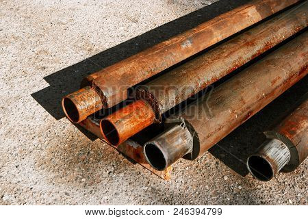 Old Rusty Hot Water Pipes On A Ground , Can Be Used As Industrial Background Element