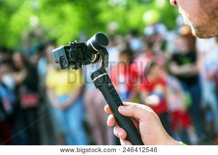 A Steadycam With Action Camera In Hand