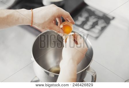Cook Pours Yalk Of The Egg In Metal Plate