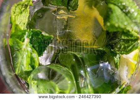Twigs Green Mint In Mojito With Slices Lime, Ice Cubes, Straw, Macro, Texture, Blur