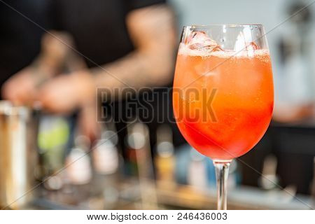 Bartender Finished Decorating His Cocktail With Mint. Orange Cocktail With Ice