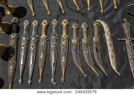 Daggers And Knives In Steel Case In The Daytime On The Market.
