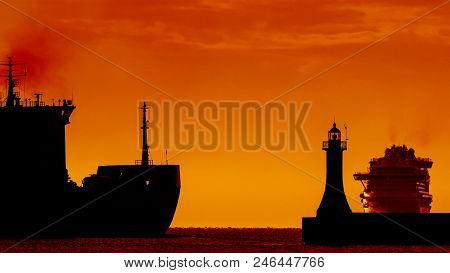 Freighter And Cruiser Ship - Ships On Water Route At Sunrise On The Roadstead Of Port In Gdynia