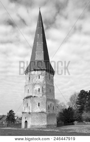 Black And White Image Of The Pointed Tower Of Saint Winoc Abbey, Bergues, France
