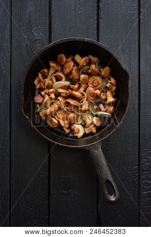 Healthy Rustic Food. Wild Mushrooms. Golden Chanterelle Mushrooms Fried In Cast Iron Pan With Onion 