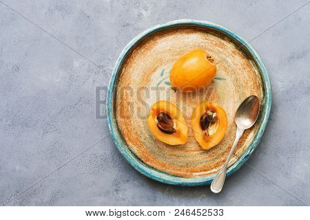 Medlar On A Plate, Gray Background. Top View, Copy Space