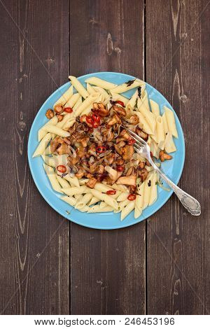Tasty Vegetarian Meal. Pasta Penne With Wild Chanterelle Mushrooms And Chili Pepper In Blue Plate On