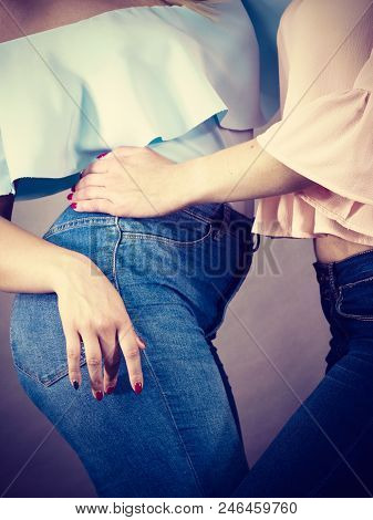 Two Unrecognizable Women Having Fashionable Outfits, Blue Jeans And Colorful Shirts. Fashion And Clo
