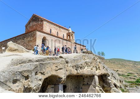 UPLISTSIKHE - MAY 5: Tourists enjoy the sunny weather and walk around the ancient rock city on 5 May 2018 in Uplistsikhe (Upliscyche), Georgia