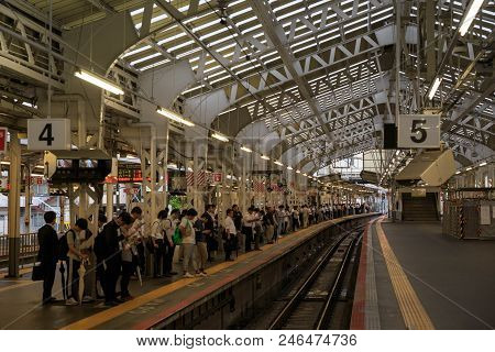 Osaka, Japan - June 21, 2018: Passengers Wait For Train Delayed Due To Heavy Rain At Jr Tennoji Stat