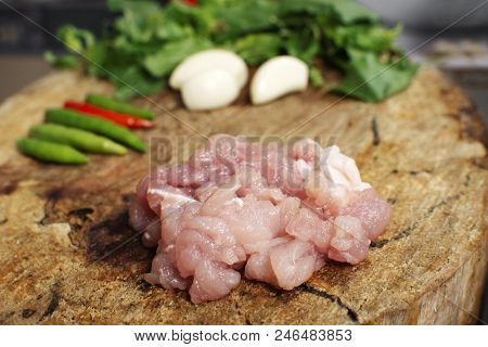 Raw Material Of Stir Fried Pork And Basil Such As Pork,basil,chilli,garlic On A Wooden Chopping Boar