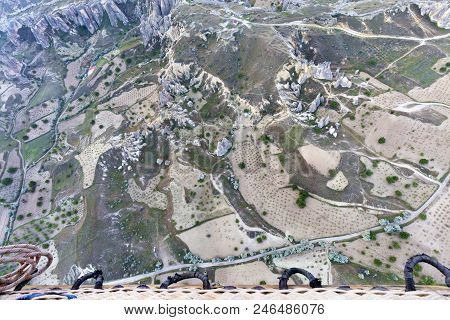 The Country Road Leads To The Village Through A Brown Valley And Fields Between The Mountains, A Vie