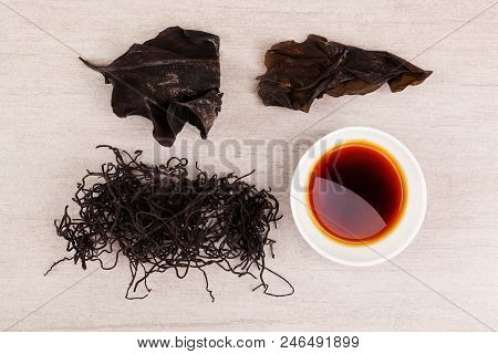 Traditional Chinese Medicine Seaweed And Dan Shen On White Background. Tcm Top View.