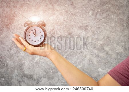 Hand Holding Clock.
