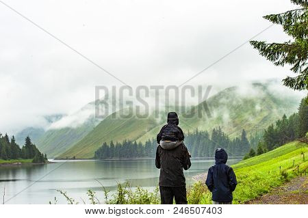 View Of A Beautlful Lake Talla In Scottish Borders With Green Hills Covered By Thick Rainy Clouds.
