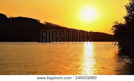 Brno Dam. The City Of Brno-europe. Beautiful Sunset By Water With A Boat.