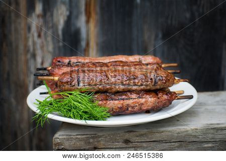 Lulya Kebab From Meat On A White Plate And Wooden Board.