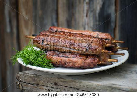 Lulya Kebab From Meat On A White Plate And Wooden Board.