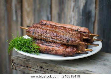 Lulya Kebab From Meat On A White Plate And Wooden Board.
