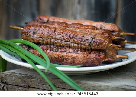 Lulya Kebab From Meat On A White Plate And Wooden Board.
