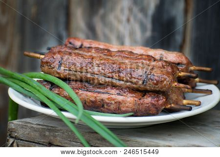 Lulya Kebab From Meat On A White Plate And Wooden Board.