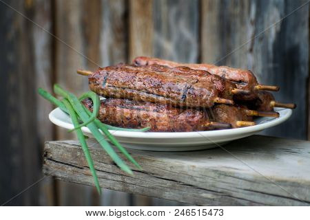 Lulya Kebab From Meat On A White Plate And Wooden Board.