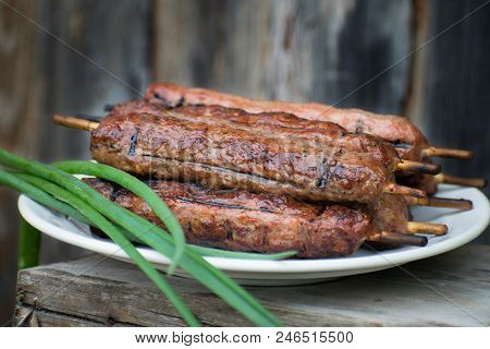 Lulya Kebab From Meat On A White Plate And Wooden Board.